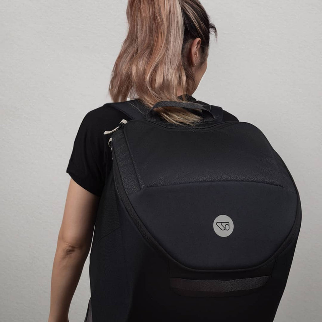 Person wearing a black WAYB Pico Car Seat Carry Bag 